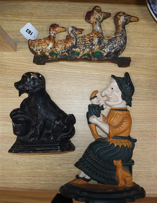 Three cast iron door stops